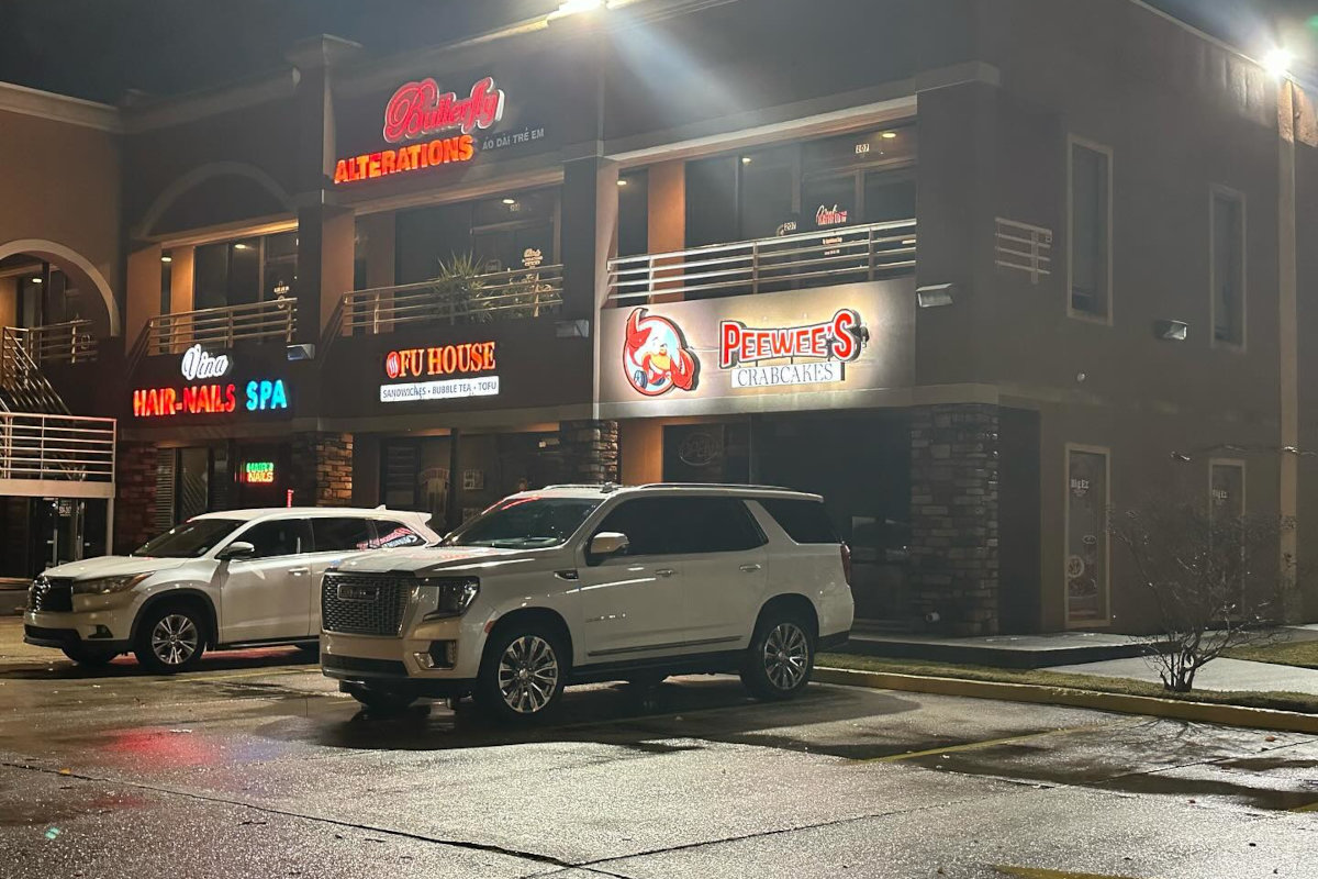 The restaurant exterior with two cars parked in front of it